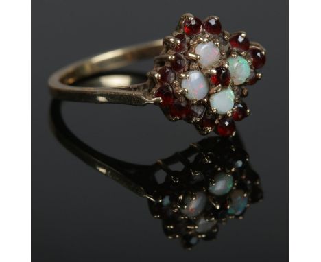 A 9ct Gold, ruby and opal cluster ring, size P½. Total weight: 2.55g.  