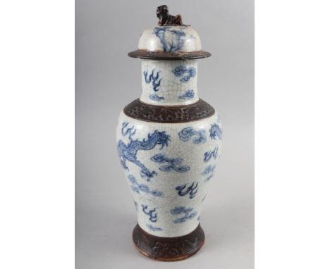 A Chinese crackle glazed jar and cover with dragon cloud scroll decoration, 14" high (cover restored)Condition:Restoration to