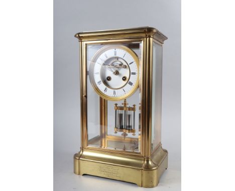 A 19th century brass four-glass clock with white enamel and gilt dial, Roman numerals and  mercury pendulum, 14 1/4" high 
