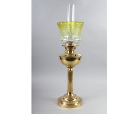 A Victorian brass oil lamp with reeded column and engraved yellow glass shadeCondition:The shade has flea bite chips to base.