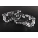 A pair of Baccarat cast and carved glass quadrant three-light candlesticks, 7" wide (chips)