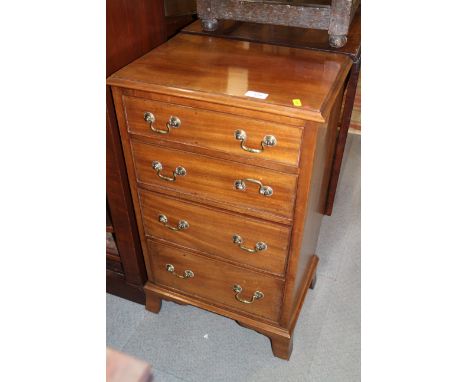 A mahogany chest of four long drawers with brass handles, on bracket feet, 17 1/2" wide x 12 1/2" deep x 29" high
