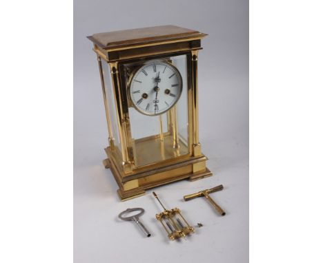 A Rapport brass four-glass clock with white enamel dial and Roman numerals, 11 1/2" high