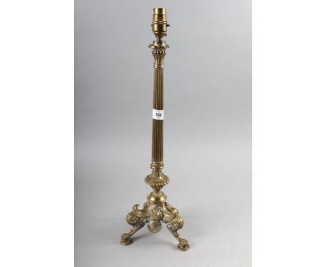 A 19th century brass candlestick, now converted as a table lamp, on tripod and lion paw feet, 20 1/2" high 