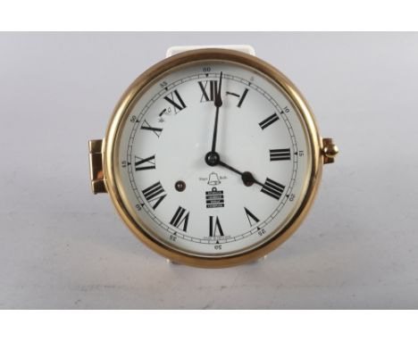 A Sewills brass cased bulkhead clock with white enamel dial and Roman numerals, 7 1/4" dia overall 