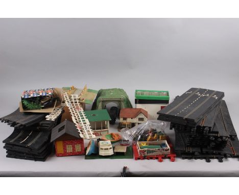 A collection of early Scalextric track, accessories including Shell hut, Dunlop hut/shed, Scalextric gate fencing, etc and a 