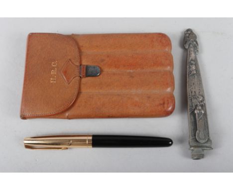 A leather cigar case with silver mount, a white metal scabbard with embossed decoration, 5 1/4" long, and a fountain pen 