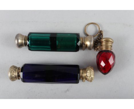 A faceted blue glass double-ended scent bottle with gilt metal mounts, another similar green glass double-ended scent bottle,