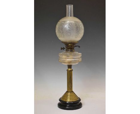 Early 20th century gilt metal paraffin lamp, the glass chimney with decorative glass shade over glass font and column stem, 6