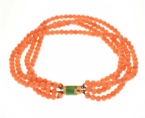 Coral four-strand bracelet with French gold and green enamel clasp, eagle's head stamp on clasp, 21cm long approx