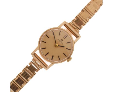 Omega - Lady's 1970s 9ct gold bracelet watch, the champagne dial with applied baton hour markers, and black hands, signed cro