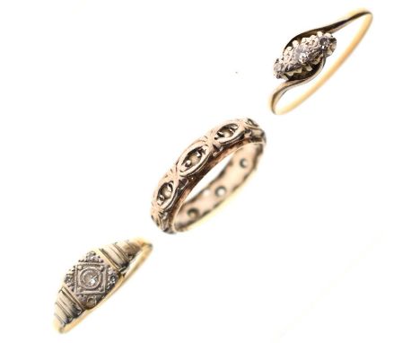Two early 20th century diamond rings, one stamped '18ct &amp; Plat, size L, the three-stone crossover ring, unmarked, size Q,