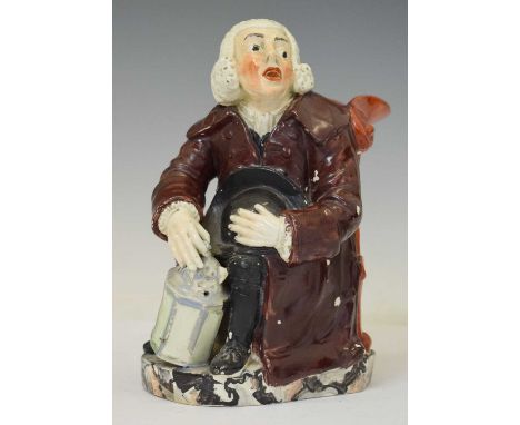 19th century Nightwatchman Toby jug, modelled seated with a lantern and wearing a heavy overcoat, 22cm high