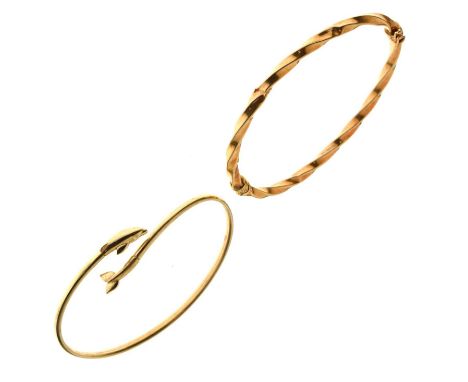 Two yellow metal bangles comprising a '9KT' dolphin torque bangle, and a '9ct' twisted hinged bangle, 7.8g approx (2)