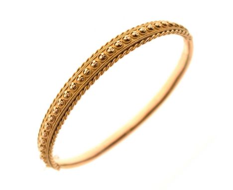 Late Victorian / Edwardian hinged yellow metal bangle having cannetille decoration, unmarked, 8.6g approx