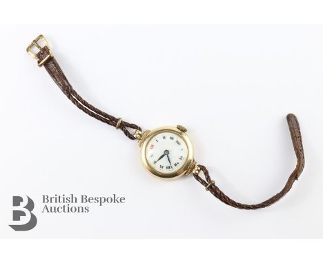 Lady's 9ct gold wrist watch, enamel face with Roman dial approx 20mm d, weight with movement approx 15 gms. Note: slight dent