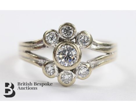 18ct white gold and diamond ring. The ring set with a central brilliant-cut diamond approx 0.2 cts with a further six diamond