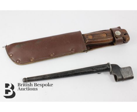 British survival knife, with leather rings to the grip, housed in a leather scabbard, approx 31 cms in length, housed in a br