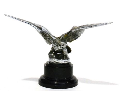A Louis Lejeune Vintage Chrome Plated Car Mascot in the form of an Eagle, raised on a circular base mounted on a black plasti