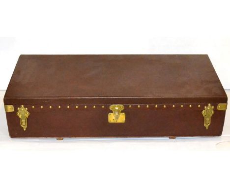 A 1920/30s Louis Vuitton Brown Leather Brass Nailed Car Trunk, hinged lid, brass carrying handle and clasps enclosing a fabri