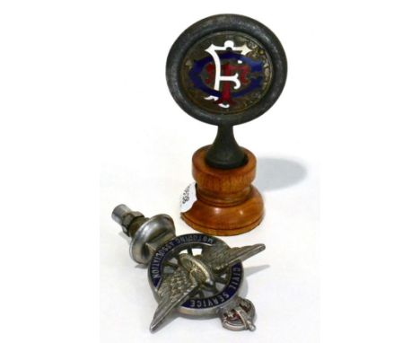 A Vintage Nickel Plated Blue Enamel Civil Service Motoring Association Car Mascot, the central wheel decorated with wings and