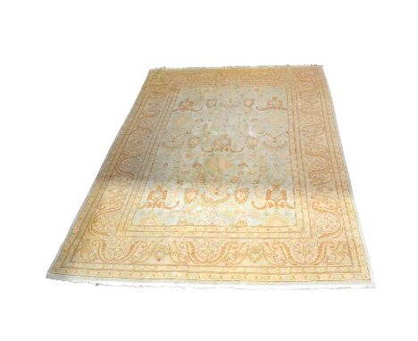 Ziegler style carpet, the pale blue field with allover large floral pattern, enclosed by deep stylised leaf borders, 366cm x 