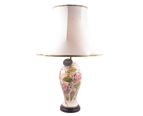 A Moorcroft table lamp, Emma Bossons design Pirouette Breeze on cream ground, cream shade, height of lamp base 34cm.
