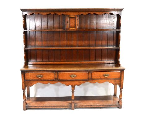 Reproduction oak dresser, two shelf delft rack incorporating a cupboard, the base with three drawers, pot-board base, width 1