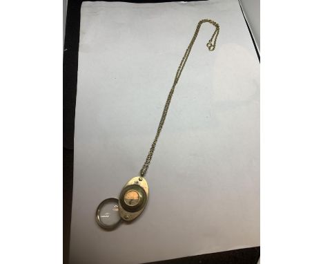 A COMPASS AND MAGNIFYING GLASS ON A CHAIN 