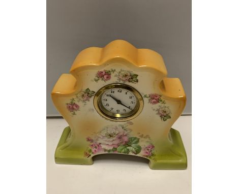 A DECORATIVE CERAMIC MANTLE CLOCK WITH A DELICATE ROSE DESIGN 