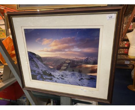 A SIGNED FRAMED PRINT OF A SNOWY MOUNTAIN SCENE 