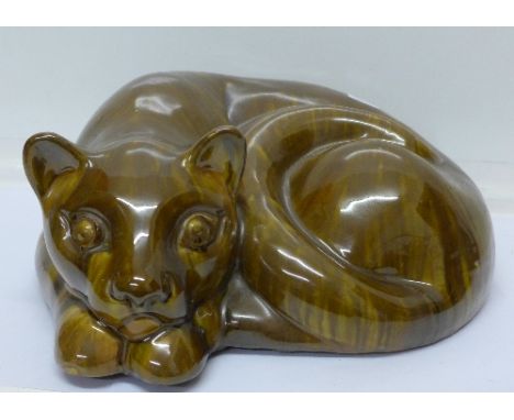 A studio pottery model of a cat lying down, signed V Proctor