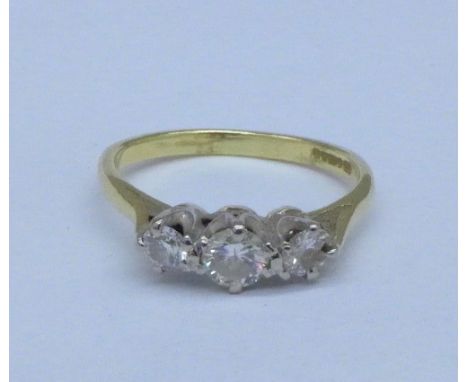 An 18ct gold, three stone diamond ring, 2.8g, K, one stone a/f