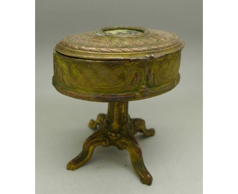 A gilt metal casket in the form of a piano stool with portrait inset to the lid, height 12.5cm