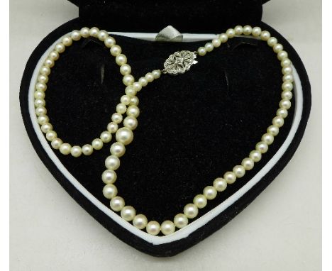 A pearl necklace with 9ct white gold and diamond set clasp