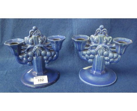 Pair of Carter, Stabler and Adams Poole Pottery two branch grapes design, blue glazed candelabra with circular terracotta bas