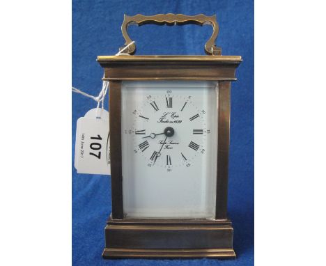 French brass carriage clock with full depth enamel face, having Roman and Arabic numerals and marked: L'Epie, with key.  12cm