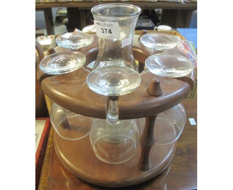 Modern hardwood circular decanter or glass stand containing six wine glasses and a carafe.(B.P. 24% incl. VAT)