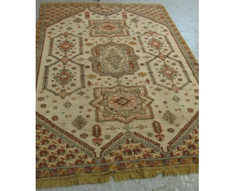 Middle Eastern design carpet on a beige ground with geometric and foliate decoration.(B.P. 24% incl. VAT)   CONDITION REPORT: