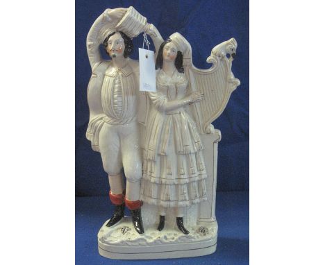 Large 19th Century Staffordshire Pottery flat backed figure group depicting a pair of country musicians, he with concertina, 