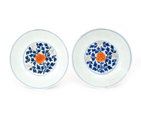 A pair of Chinese Qing Dynasty 18th Century porcelain dishes of shallow circular form hand painted in underglaze blue heighte