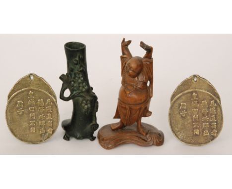 A carved hardwood figure of a seated Buddha, a similar figure of Hotei with arms raised, a Japanese bronze flowering bough, a