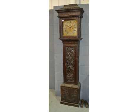 An 18th Century and later carved oak longcase clock with eight day striking movement, the brass dial with silvered chapter ri