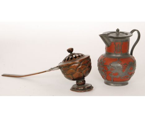 A late 19th and early 20th Century bronze Buddhist incense burner, engraved floral handle to a raised lotus shaped bowl and p