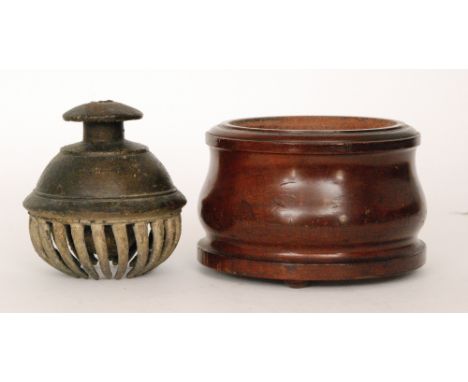 A bronze Tibetan claw prayer bell within an associated turned wooden stand, diameter 17cm.