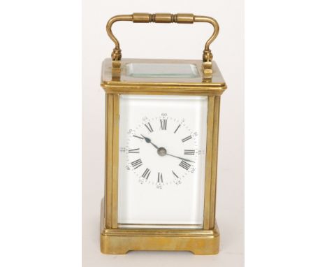 A late 19th Century French brass carriage clock with white enamelled dial striking on a gong, height 11cm in associated case 