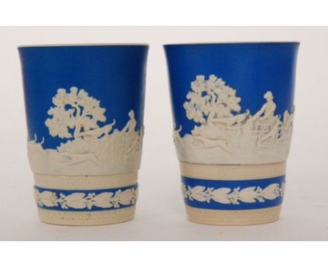 Two Copeland Spode blue jasperware beakers, each decorated with applied relief moulded hunting scenes against a blue ground, 