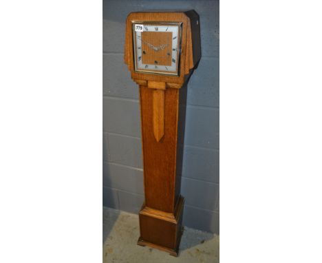 A late 1930s Art Deco style oak Grandmother clock striking on a gong on stepped bracket plinth base, height 134cm
