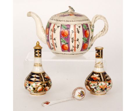 An early 19th Century creamware teapot of globular form decorated with hand painted panels of apples against a purple ground,