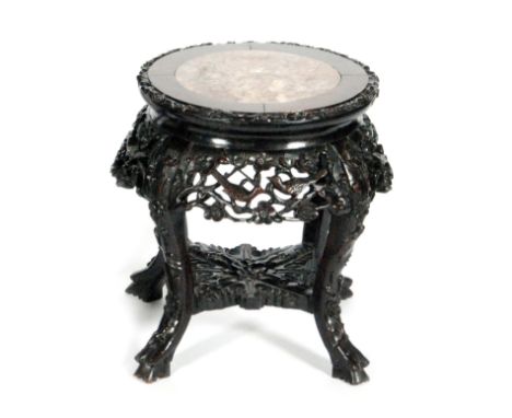 An Oriental export hardwood jardiniere stand with rouge marble inset top above the apron carved with prunus blossom and birds